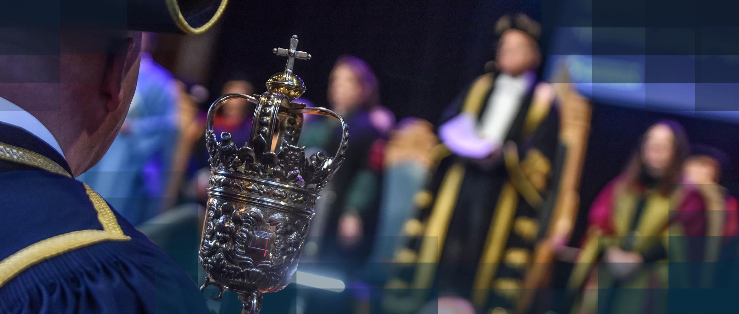 Graduation ceremony with focus on the Sacrist's mace