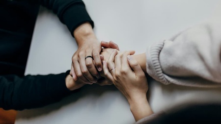 An arm holding another arm supportively