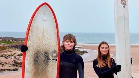 students with surfboard