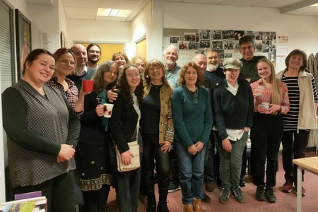 A group of smiling people in a room