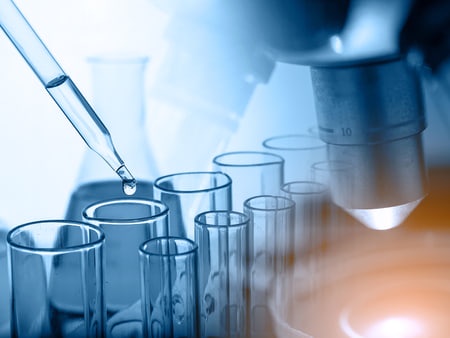 A composite image of a microscope, vials and a pipette