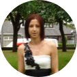 Woman with short red hair wearing black and white dress