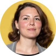 Woman with brown hair in front of yellow background