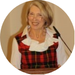 Woman with short grey hair in front of microphone