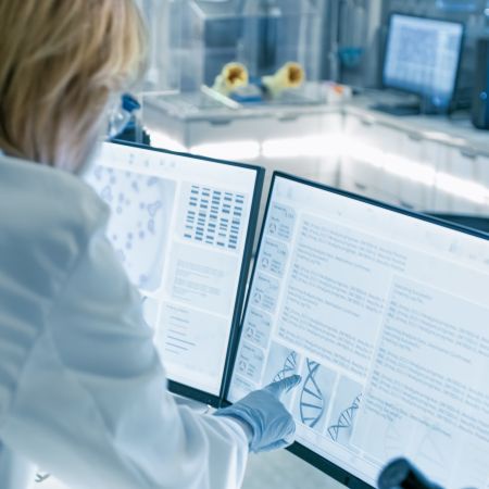 A woman looking at health data on a monitor