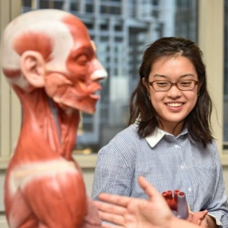 A female student stood beside a dummy