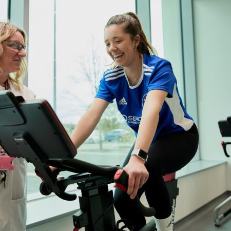 A student riding an exercise bike