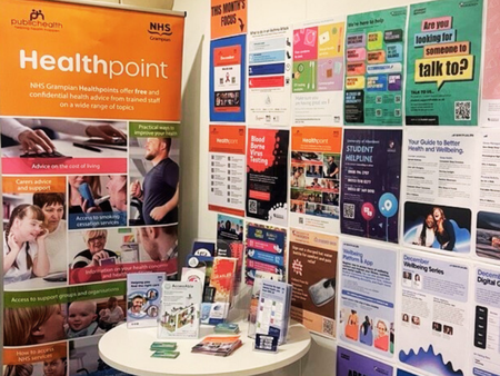 picture of the health info point with lots of health flyers and posters displayed on wall, banners and small table