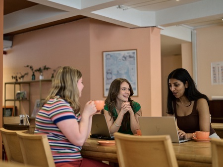 Students on laptops in cafe