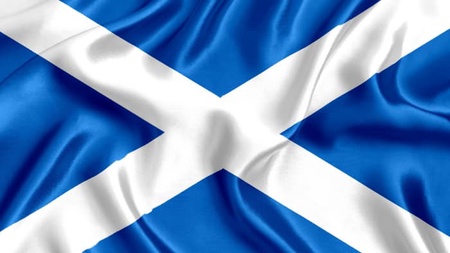 The Scotland flag of a white cross on a blue background.