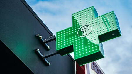 A green illuminating sign for a pharmacy or chemist