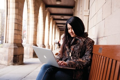 Student using laptop outside Elphinstone Hall