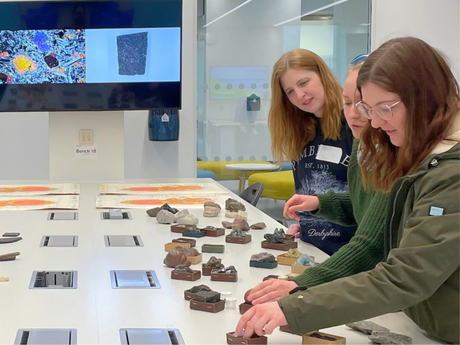 Three female adults examine rock and mineral samples in the University of Aberdeen's Science Teaching Hub