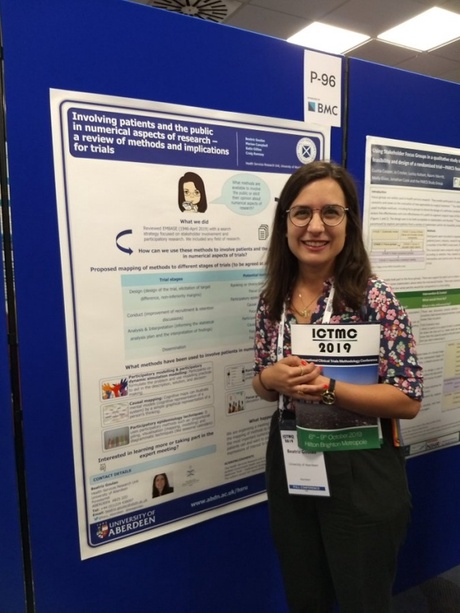 Beatriz Goulao with her poster on methods to involve patients and the public in numerical aspects of trials