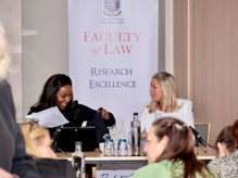 Picture of Dr Onyoja Momoh presenting on panel with Lauren Carmichael (Ex-Patriate Law),