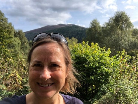 Dr Annette Davison in front of hills and trees