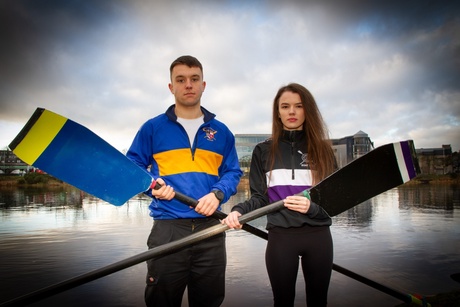 Jakub Zbikowski and Jill Adam holding rowing oars with the River Dee behind them