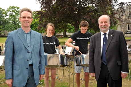 Stewart Aitken and Professor Albert Rodger with two members of the TLA Steel Band from London.