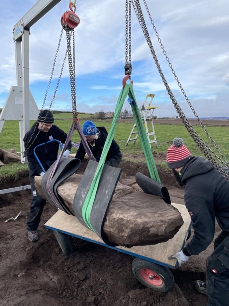 The team lifting the stone at Aberlemno