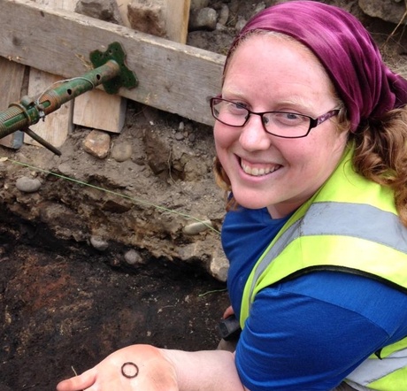 Cathy MacIver of AOC Archaeology with a bronze ring from the excavations
