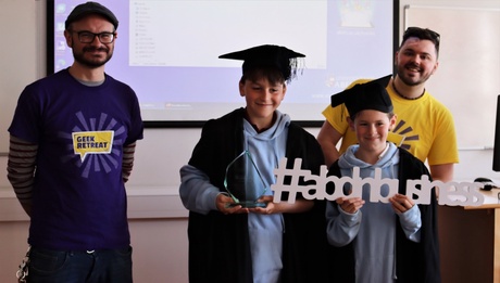 Pupils from Dunnottar School with their trophy and two of the team from Geek Retreat