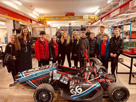 The pupils in one of the Engineering labs with the TAU Racing car