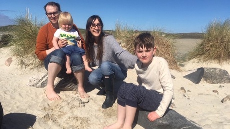 Jessica Wood - with her husbands and two sons - overcame a pregnancy-related illness to graduate