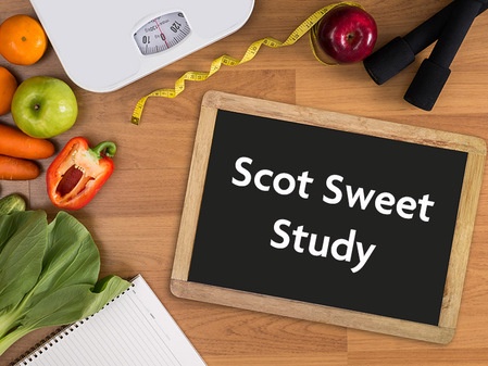 some fruit and weight scales next to a board with the title Scot Sweet Study