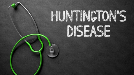 The words Huntington's Disease written on a chalkboard with a stethoscope laid alongside