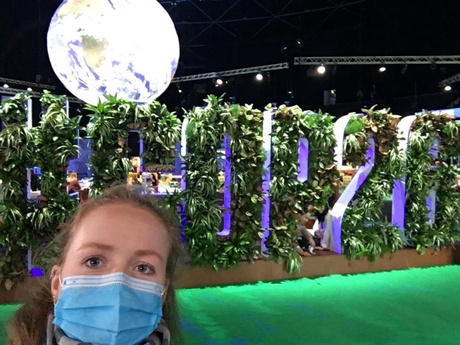 Julia Leng taking a selfie in front of the living wall at COP26