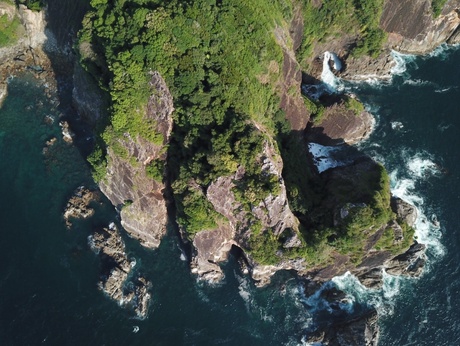 An aerial view drone shot of a costal section of a lush Myanmar island