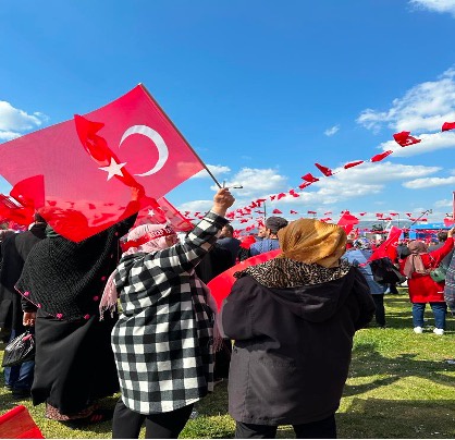 Crowd at a Erdogan rally, waving Turkish flags.