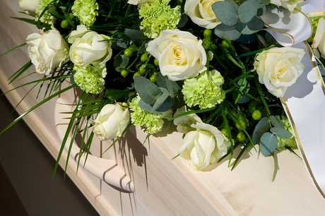 Flowers sitting on top of a coffin