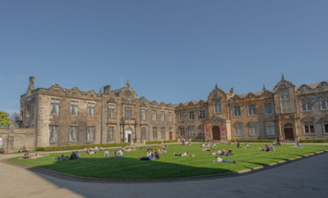 Building wth green grass and people