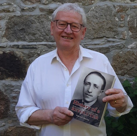 Man holding book in front of granite wall