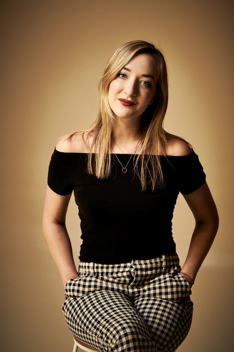Portrait photograph of woman sitting on stool