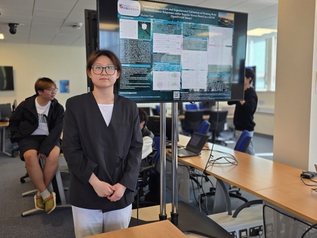 Student presenting their academic poster from their research project