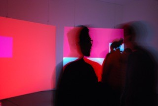 Two adults looking at a digital piece of art