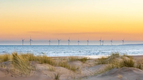 Image of beach with wind farm in background