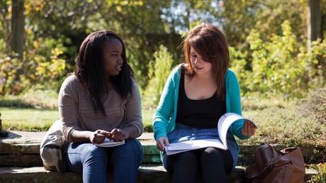 Two female students sitting in the Botanic Gardens