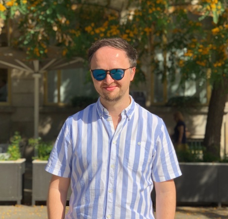 Picture of Davdi standing in front of some trees.