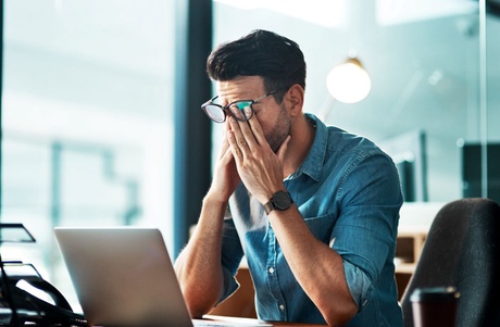 Picture of a man at desk in pain