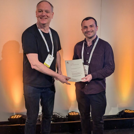 Picture of Dr Macdonald receiving his prize.
