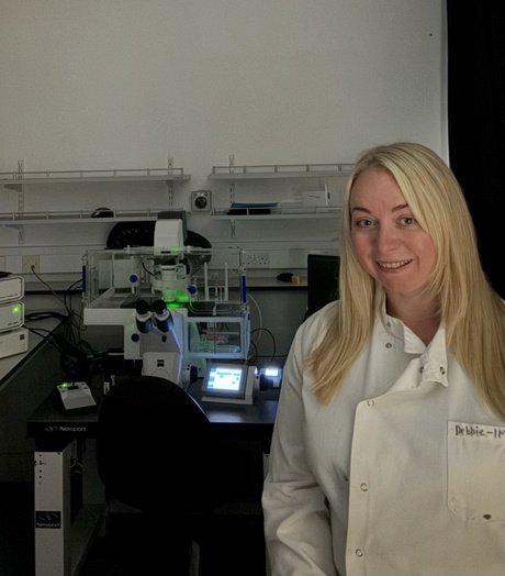 Dr Debbie Wilkinson pictured with Microscope