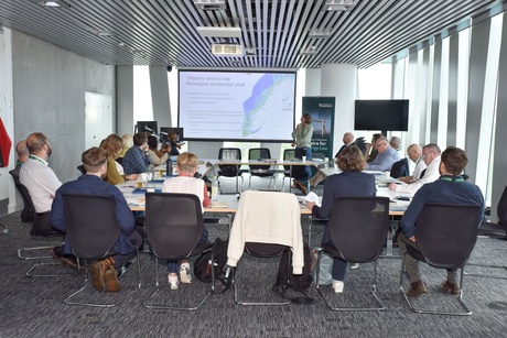 group of people sitting at a meeting table