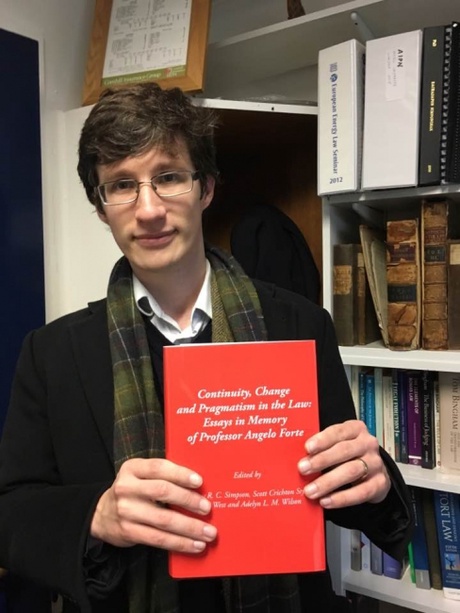 Andrew Simpson holding the volume