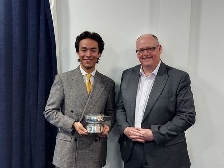 Photograph of Prize winner Levent Ciceker, holding the Quaich, alongside Head of Law School Prof Greg Gordon