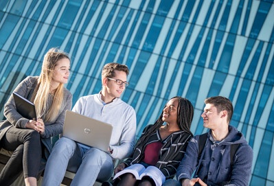 Group of students sitting outside the Sir Duncan Rice Library