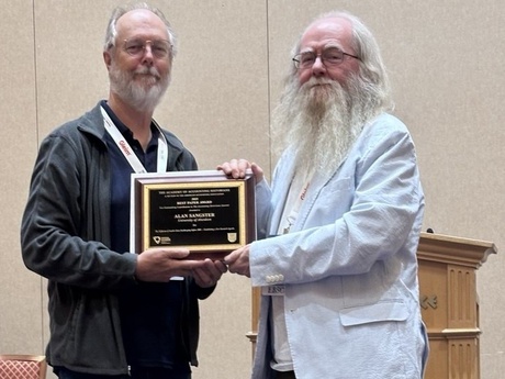 Two men holding an award