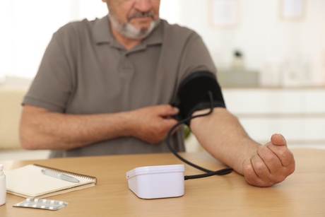 Man with chest pain takes blood pressure